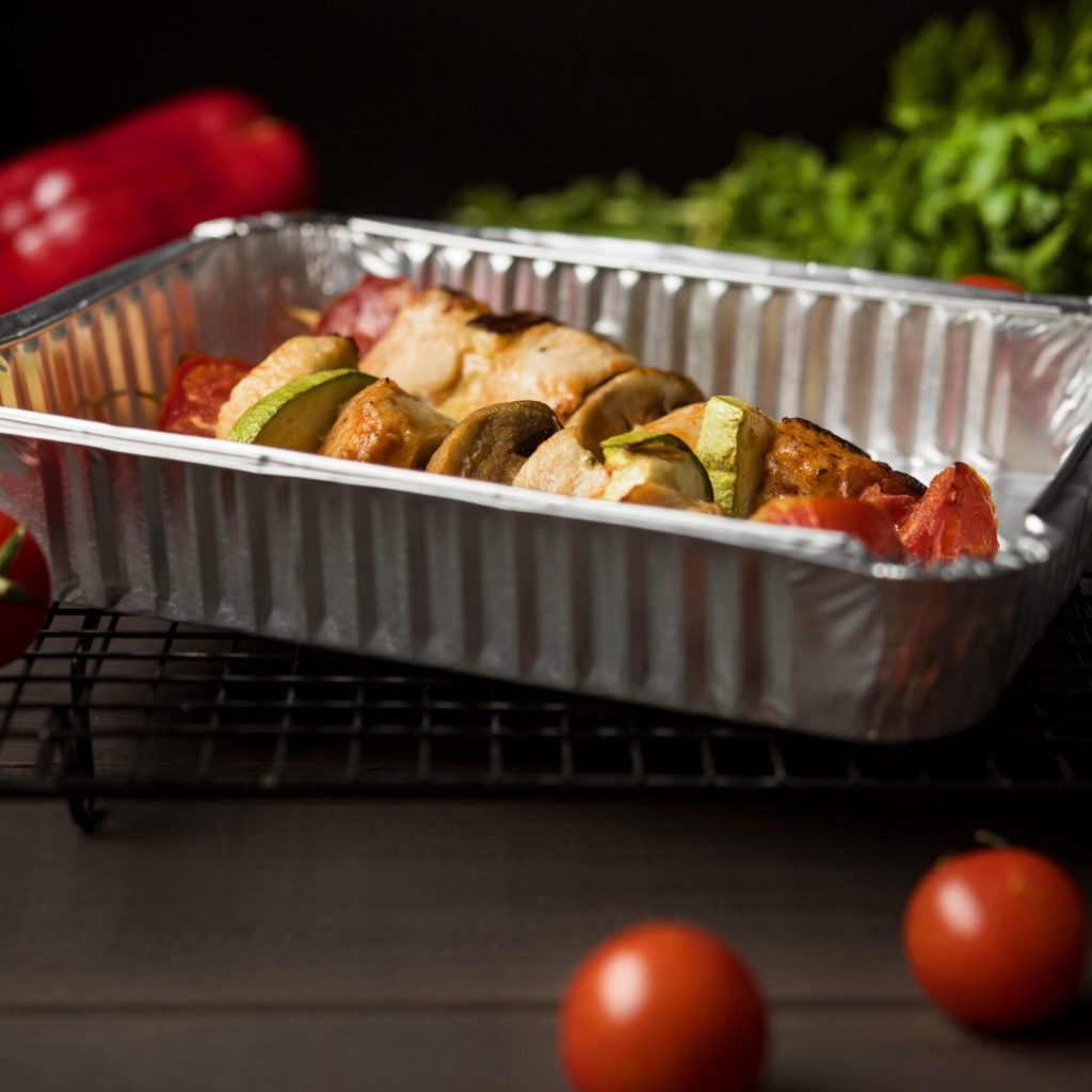 high angle chicken skewers tray with red pepper cherry tomatoes