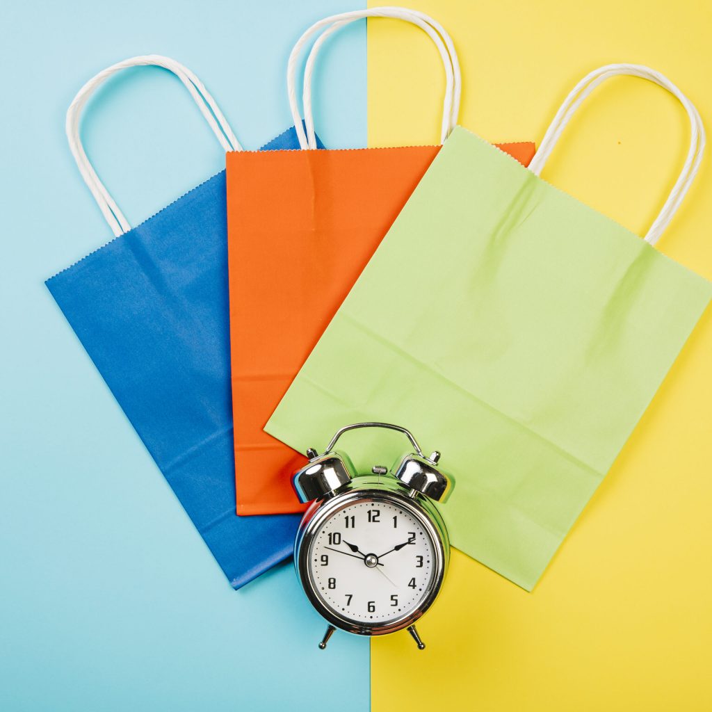 sales concept with three bags alarm clock
